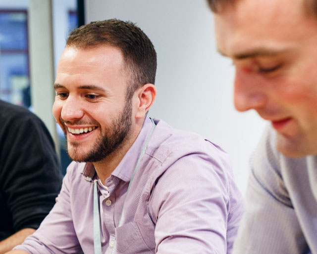 image_640_514_two_men_looking_down_at_desk.jpg